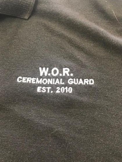 Black shirt with white embroidered text reading "W.O.R. Ceremonial Guard Est. 2010.