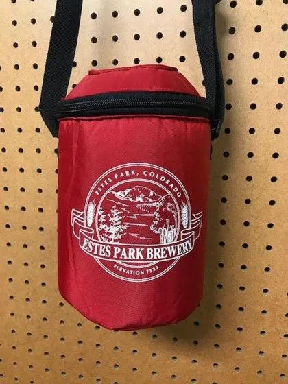Red insulated bag with "Estes Park Brewery, Estes Park, Colorado" logo, hanging on a pegboard wall.