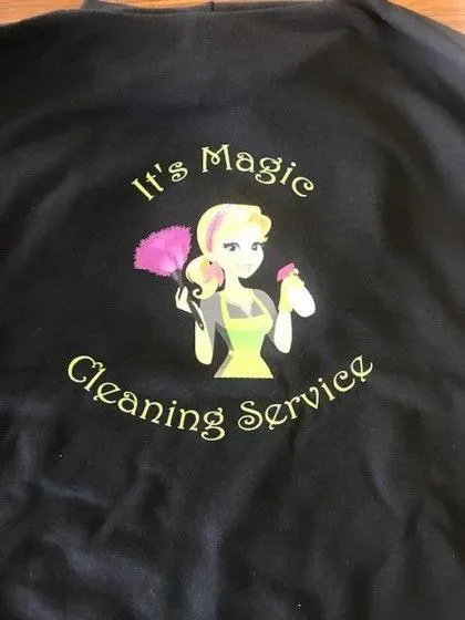 Logo for "It's Magic Cleaning Service" featuring a cartoon woman with a duster and spray bottle on a dark fabric background.