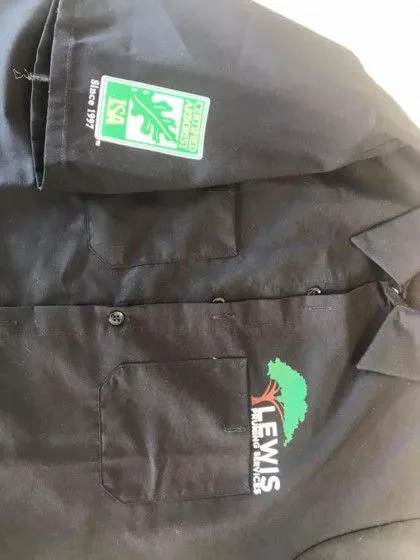 Black collared shirt with "LEWIS" logo and green patch labeled "Certified Arborist" on the sleeve.