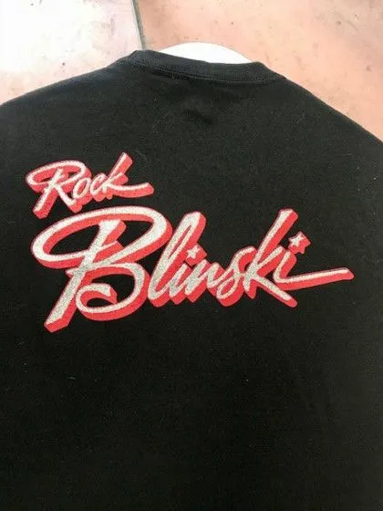 Black shirt with red and white text that reads "Rock Blinski" in a stylized script font.