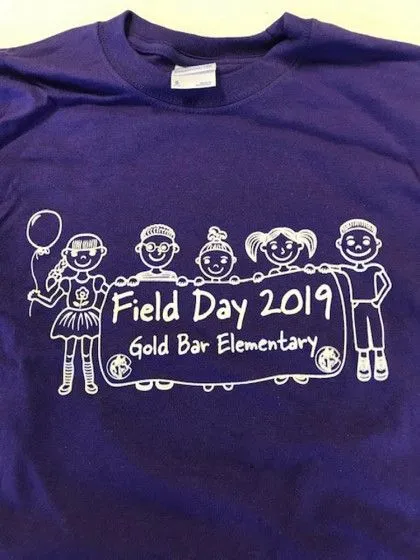 Purple t-shirt with cartoon kids holding a sign that says "Field Day 2019, Gold Bar Elementary.
