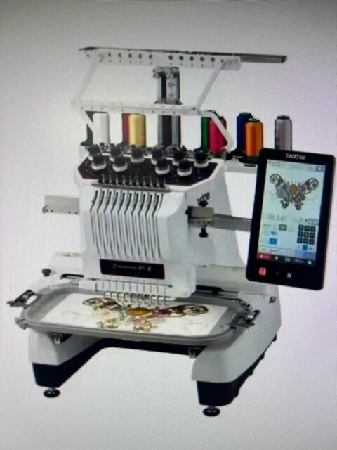 A computerized embroidery machine with multiple thread spools and a touchscreen displaying a butterfly design.